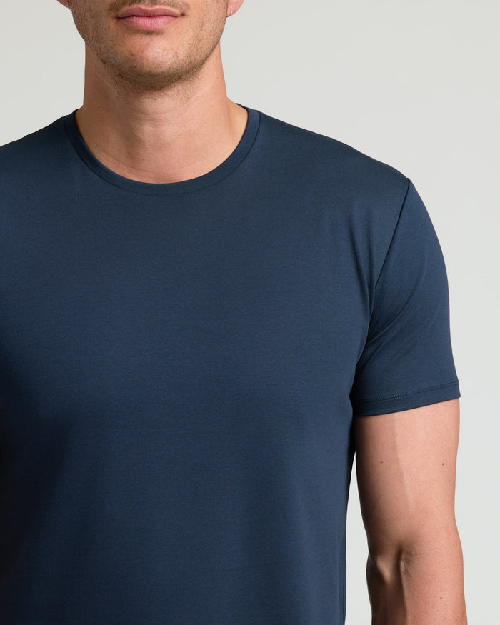 Close-up of a man wearing a Navy Tall Pima Cotton Blend Curved Hem Crew, showcasing the smooth fabric and classic crew neckline in a men's basics style.