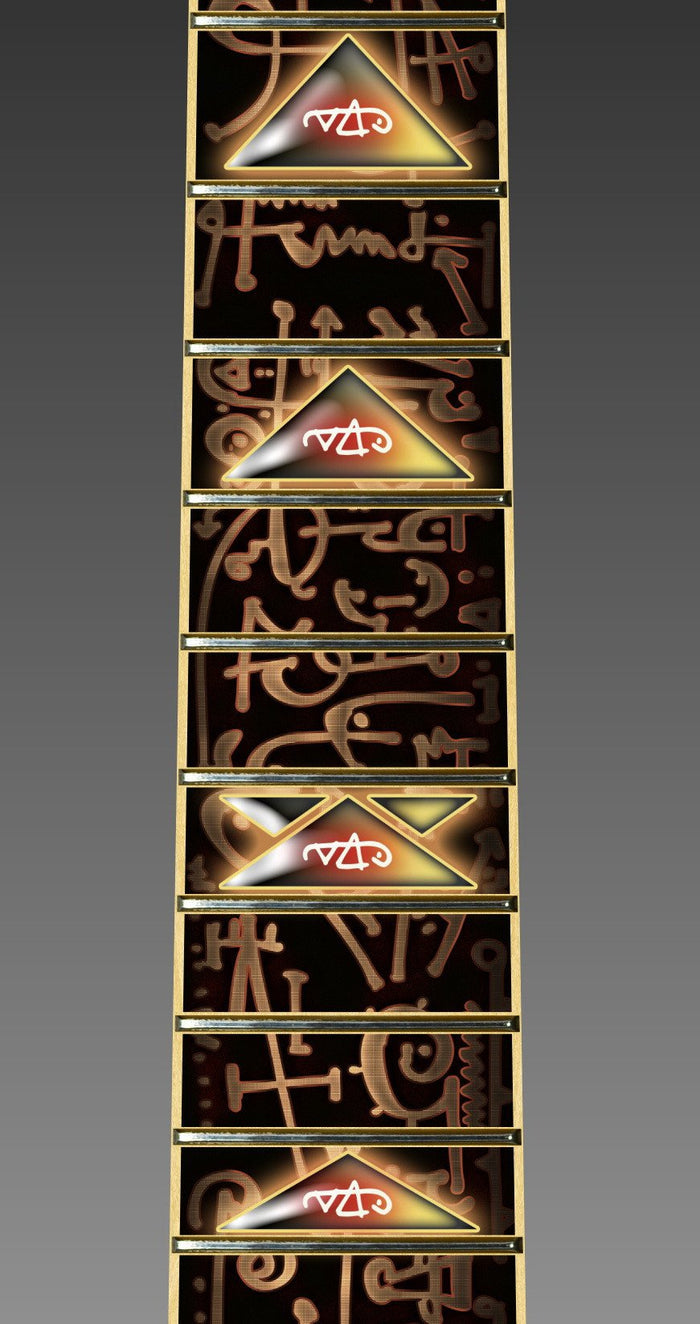close up image of a guitar neck against a grey background. there is a fret protector on the guitar. It is black with light brown symbols all over it. Every other fret has a brown, black and greenish triangle on it with a white steve vai logo in the center of it. The steve vai logo makes the word "vai" with an upside down triangle, a right side up one, and a line going across the triangles with a curl at the end next to the triangle that is upright.