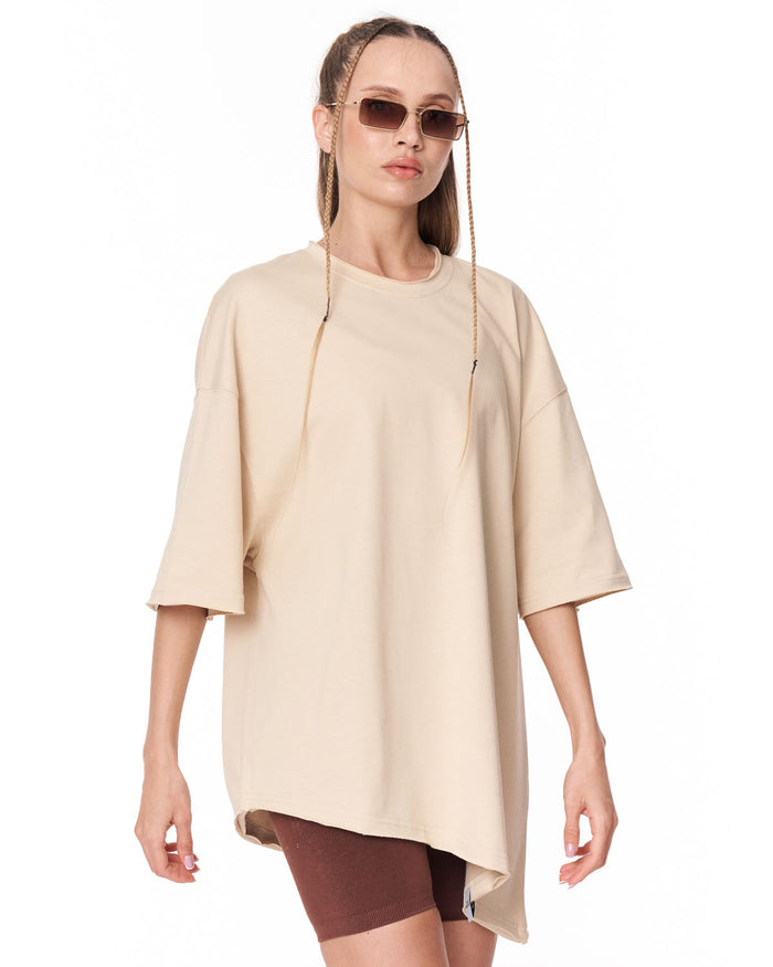 Women's Oversized Asymmetrical Beige T-Shirt styled with biker shorts