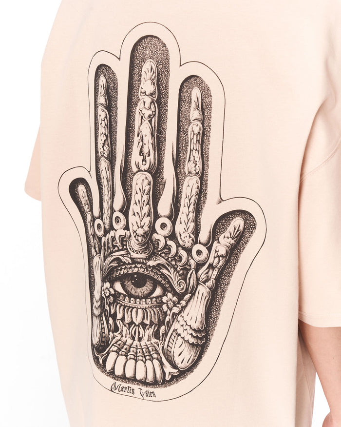 Oversized Chest 3D Printed Back Transfer Printed Beige T-shirt paired with white sneakers