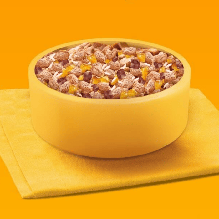 Yellow background with a yellow bowl of Pedigree wet puppy food pictured.