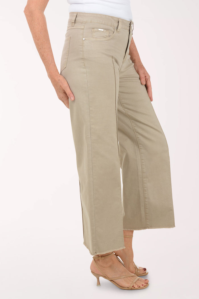 A woman wearing a flared brown crop pant.