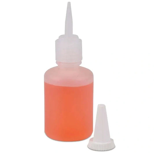 Orange liquid bottle with white cap on a white background