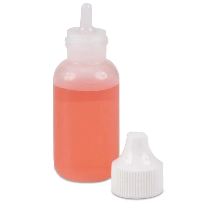 Bottle with red liquid and white cap on a white background
