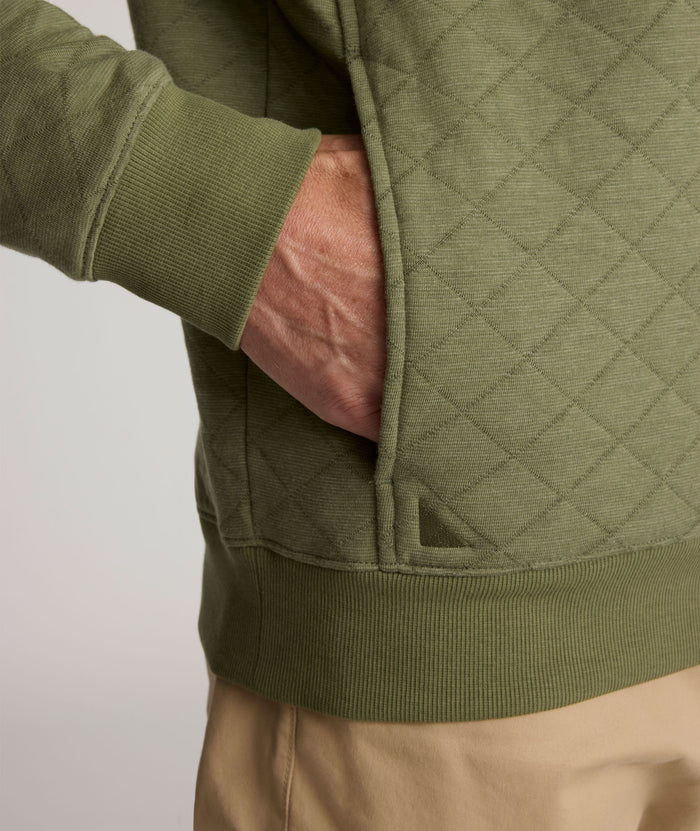 Model is wearing UNTUCKit Garrison pullover in olivine.