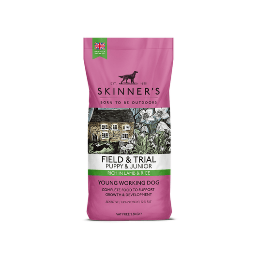 A 2.5kg bag of Skinner's Field & Trial Puppy & Junior Lamb & Rice dog food, designed for young working dogs, featuring a mauve packaging design with a central illustration of a rustic cottage. On a white background.