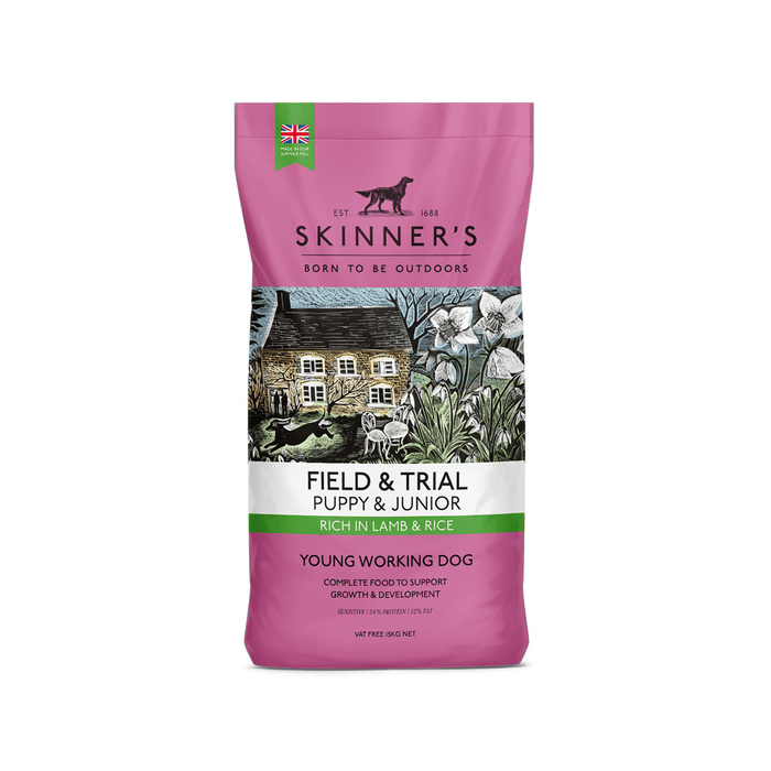 A 15kg bag of Skinner's Field & Trial Puppy & Junior Lamb & Rice dog food, designed for young working dogs, featuring a mauve packaging design with a central illustration of a rustic cottage. On a white background.