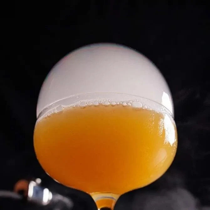 Close-up of a glass filled cocktail with a smoke bubble from Breville Commercials smoke bubble kit P516.