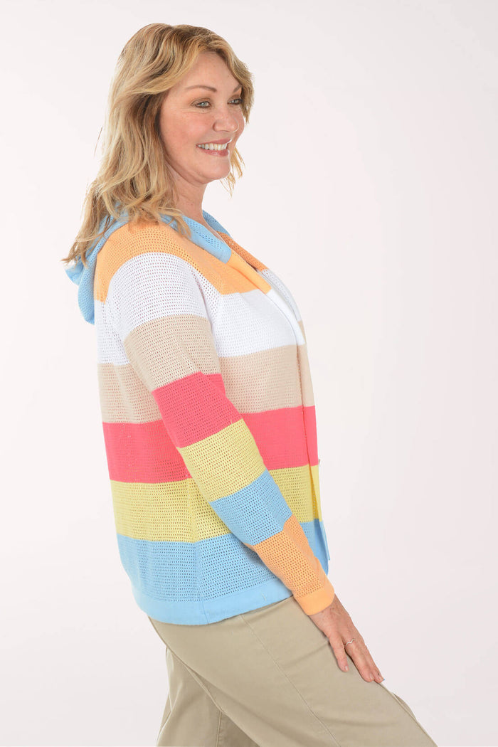 Woman wearing a colorful striped sweater on a white background