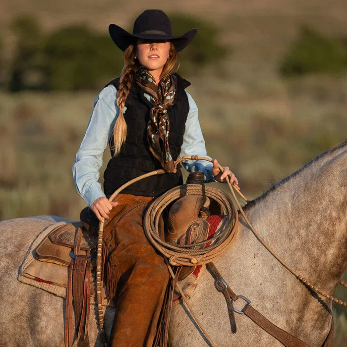 Cowgirl on horseback with rope