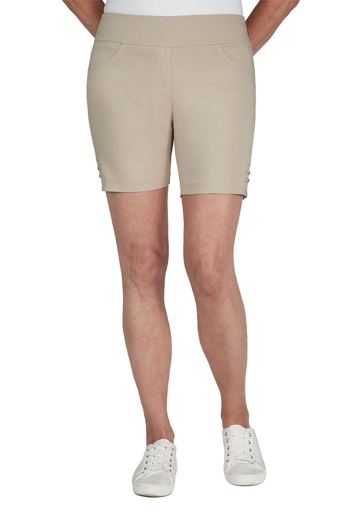 Beige shorts worn by a person on a white background