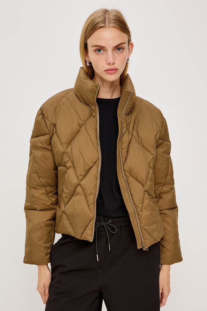 Summit Cropped Puffer Jacket With Stand Collar, Front Zipper, Quilted Detailing, Side Pockets, Tonal Branded Stamp, and Long Sleeves in Ginger Colorway - Upper Body Front View Featured on Model