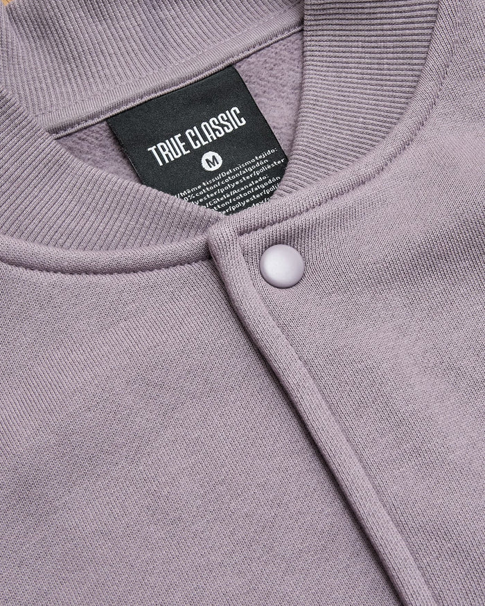 Thistle Fleece Bomber Jacket with snap-front, rib texture, and TRUE CLASSIC label.