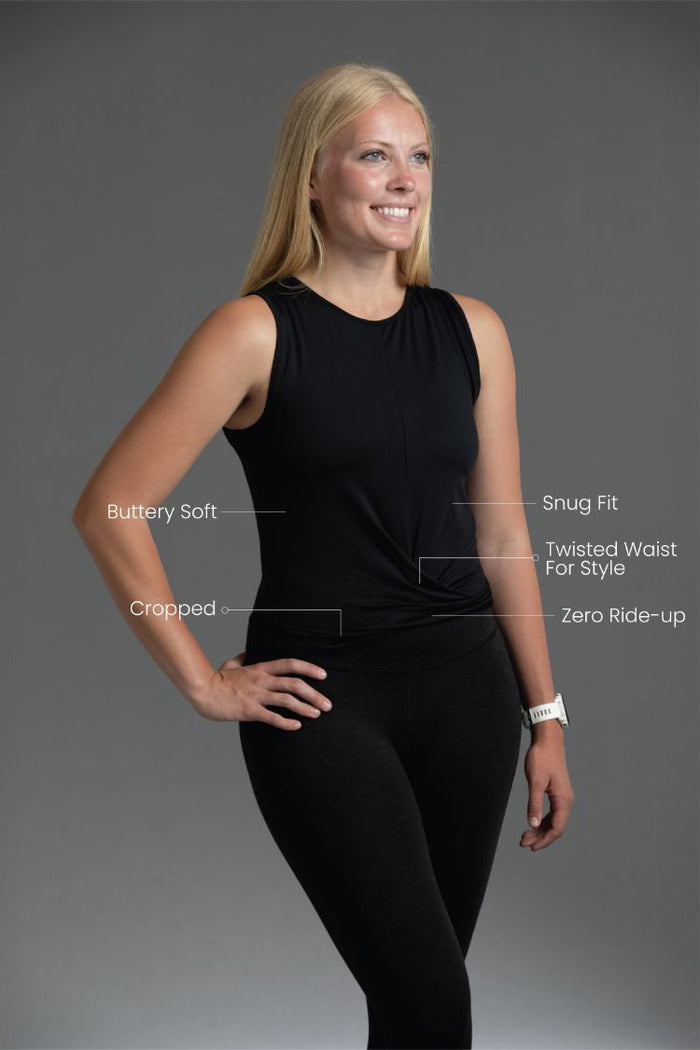Woman wearing a black sleeveless top and leggings with feature text on a gray background | Black