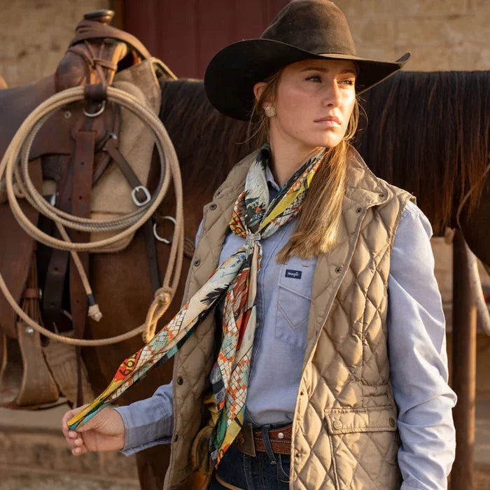 Cowgirl in vest and hat near horse