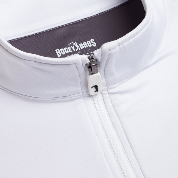Close-up of the White - Q-Zip jacket featuring a stand collar, athletic fit, golfer logo zipper pull, and “BOGEY BROS GOLF CO.” label. The smooth, slightly shiny fabric offers comfort with moisture-wicking performance.