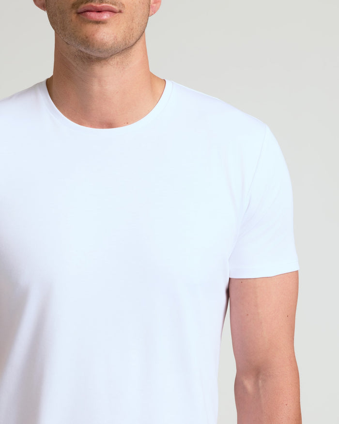 Close-up of a man wearing a white Tall Pima Cotton Blend Curved Hem Crew 7-Pack t-shirt, showcasing the smooth fabric and classic fit for men's basics.