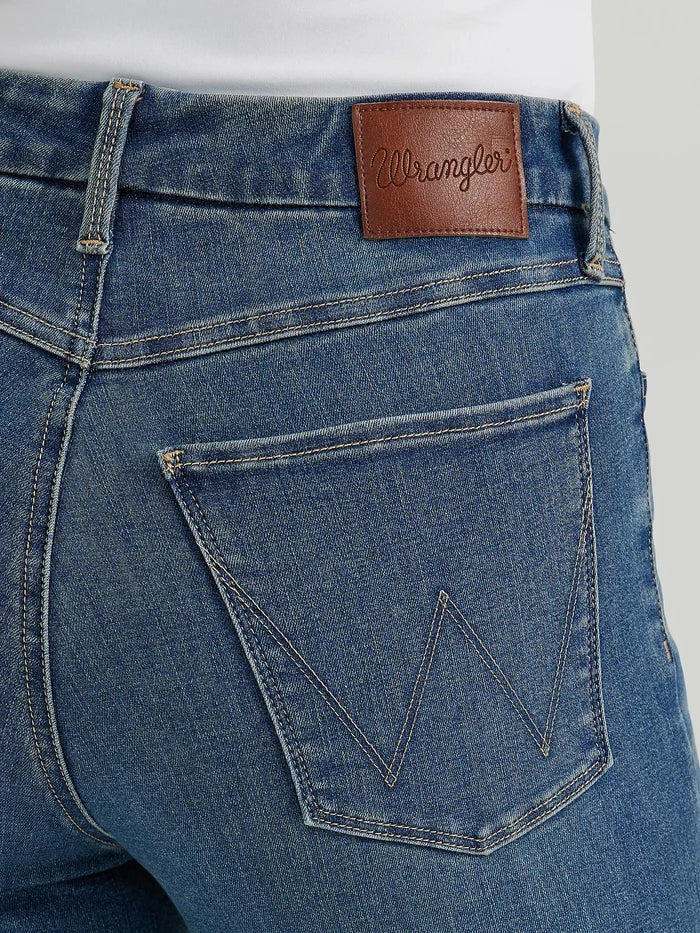 Close-up of blue jeans with a Wrangler leather patch.