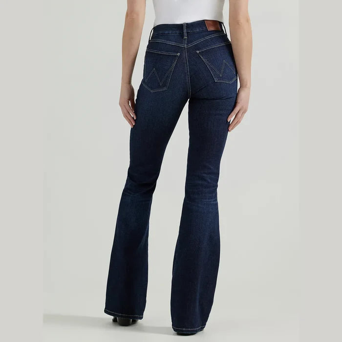 Woman wearing dark blue flared jeans.