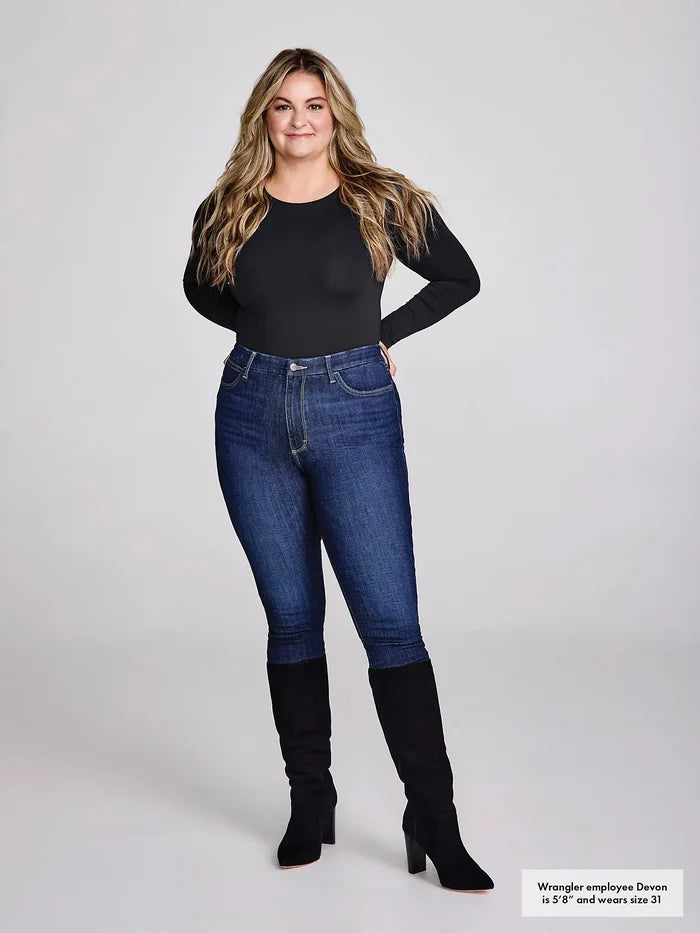 Woman in black shirt, jeans, and boots.