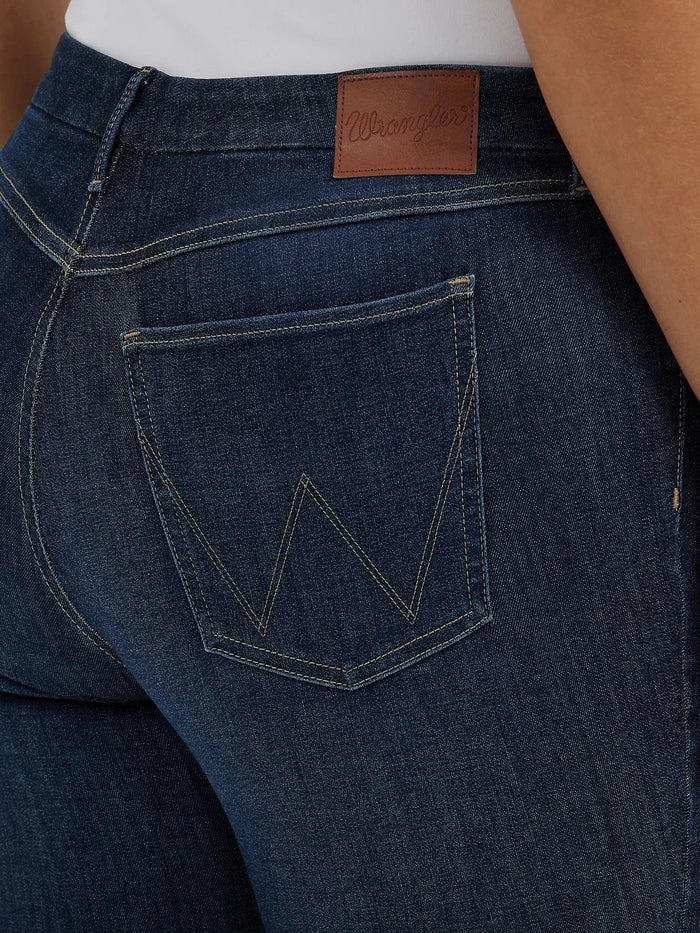 Close-up of dark blue Wrangler jeans with back pocket.